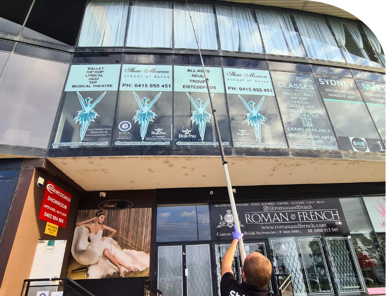 Shimmer Technician using the water fed pole system to reach 3rd floor window of the Sydney shopping mall