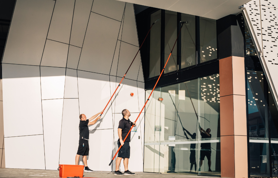 how to choose a window cleaning company sydney - technician completing a service report after commercial window cleaning in Sydney
